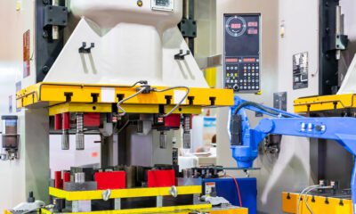 Automatic hydraulic press stamping machine with press mold or die fixture for metal sheet forming in manufacturing process in industrial with robot arm and suction cup